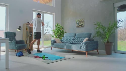Man Performing Floor Exercises on Mat in Home