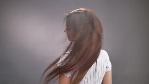 Woman Smiling and Tossing Hair in Studio