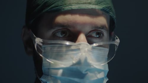 Medical surgeon operates in the operating room with glasses