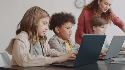 Students Using Portable Computers on Lesson