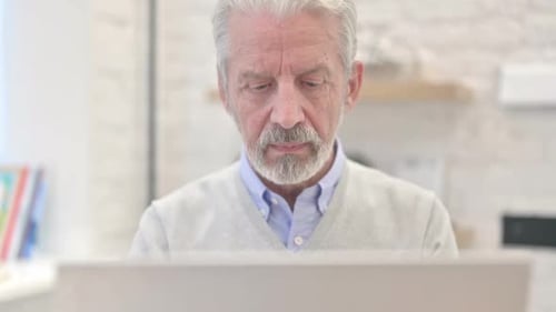 Close Up of Serious Old Man Looking at Camera