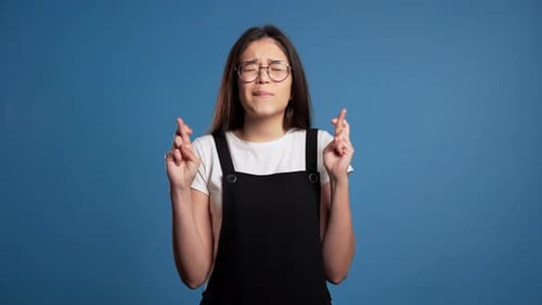 Teenage Girl Crossing Fingers Hoping For Good Luck