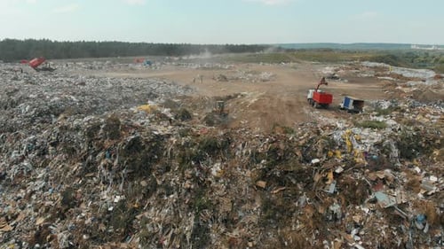 Aerial View at Garbage Dump, Tractor and Staff Shovel Up the Trash
