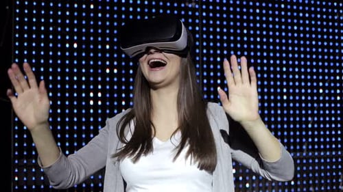 Woman Uses VR Headset in Front of Lights