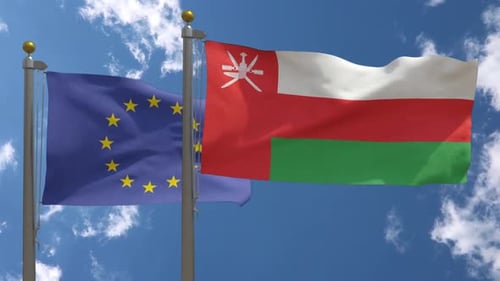 European Union and Oman Flags Waving Realistically Under Blue Sky