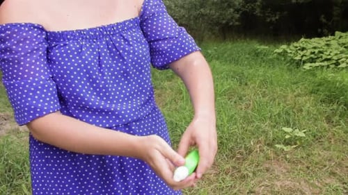 Young Woman in a Forest Puts a Mosquito Repellent on Her Skin