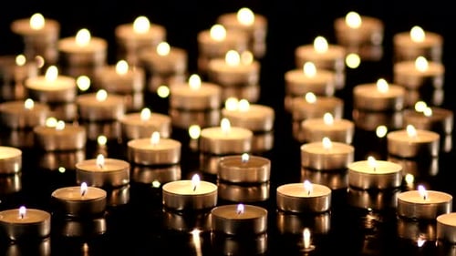 Candles Burning on a Black Background
