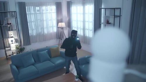 Masked Figure Shining Flashlight being Recorded by Camera