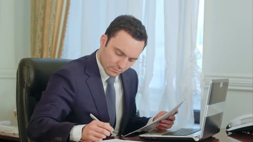 Young Man Working at Desk in Office