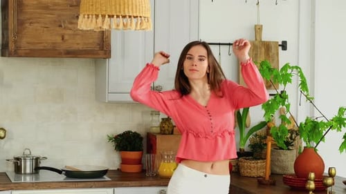 Young Woman Dancing in a Rustic Kitchen