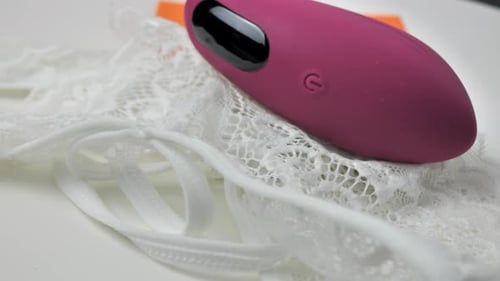 Pink Sex Toy on White Lace Intimates Pink Sex Toy on White Lace Intimates