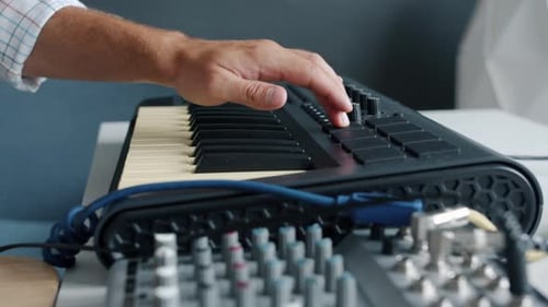 Closeup Slow Motion of Male Hand Adjusting Keyboard Then Playing Musical Instrument in Studio