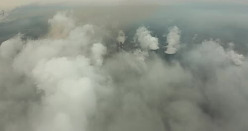 Epic Aerial of High Pipes with Smoke Emission. Plant Pipes Pollute Atmosphere. Industrial Factory