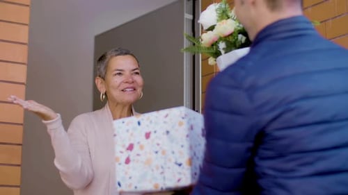 Man Delivers Flowers and Gift to Delighted Woman