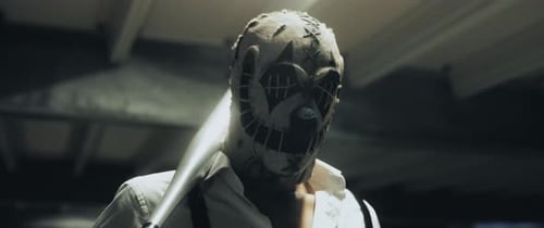 Masked Figure with Baseball Bat in Dark Location