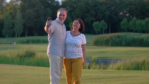 Happy Mature Couple Relaxing Park Using Smartphone