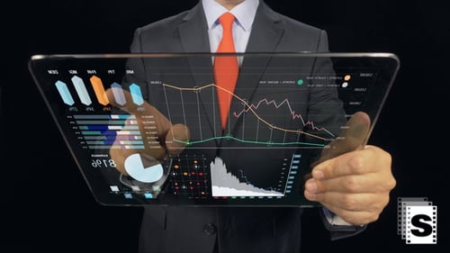 Man Holds Tablet Displaying Data And Animated Graphs