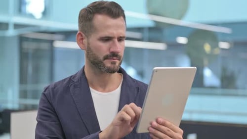 Middle Aged Businessman Having Loss on Tablet in Office