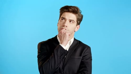 Man in Suit Thinking on Blue Background
