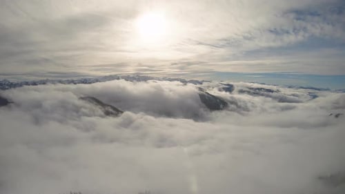 Aerial Flyback Over Mountain Ridge With Rolling Fog Over Winter Snow