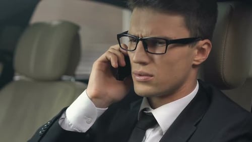 Man Talking Angrily on Phone in Car