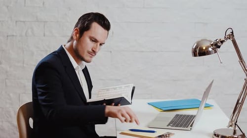 Young businessman working at the computer and calendar