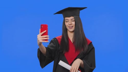 Smiling Graduate Taking Selfie with Diploma