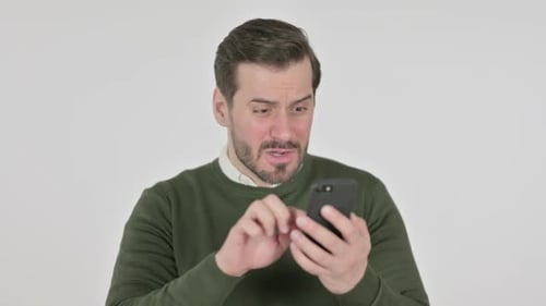 Adult Male Reacts To Content on Smartphone