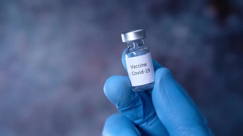 Doctor Hand in Protective Glove Holding Coronavirus Vaccine, Close Up