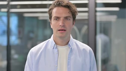 Man Talking and Pointing to the Camera