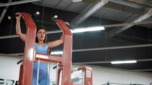 Fit Woman Doing Pulling Up Exercise on Sport Trainer in Gym Club. Athlete Woman Training Pull Ups on