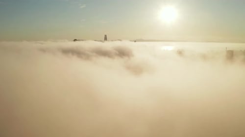 Cityscape Shrouded in Morning Fog at Golden Hour