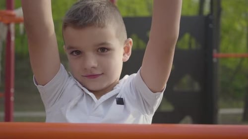 Little Handsome Boy Climbing Children's Steps on the Playground Close-up. Active Lifestyle, Carefree