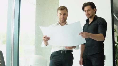 Two Architect Discussing Help Create Plan with Blueprint Home Building at Office