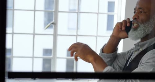 Businessman talking on mobile phone in the office