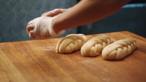 Woman making a bagel pastry with her hands
