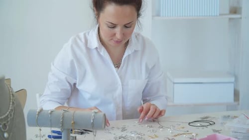 Woman Making Jewelry at Bright Table