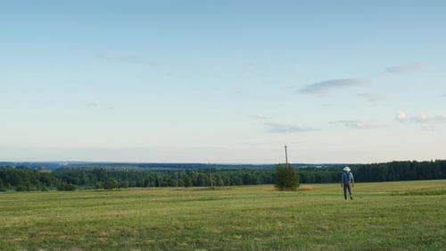 Farmer Walking in Mown Field
