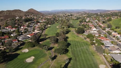 Aerial View of Golf in Upscale Residential Neighborhood During Autumn Season