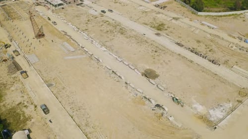 Aerial view of dry ground rough cracks in the land with sand in factory industry for construction