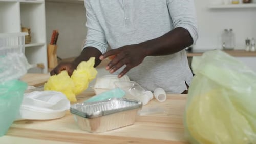Black Man Sorting Waste for Recycling at Home