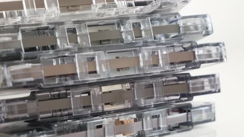 Stack of retro data analogue magnetic tapes 4K 2160p 30fps UltraHD tilting footage - Close-up of