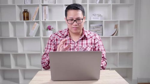 Man Talking on Laptop During Video Conference