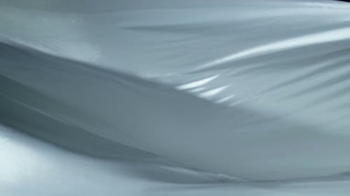Abstract Flowing White Silk Fabric on Black Backdrop