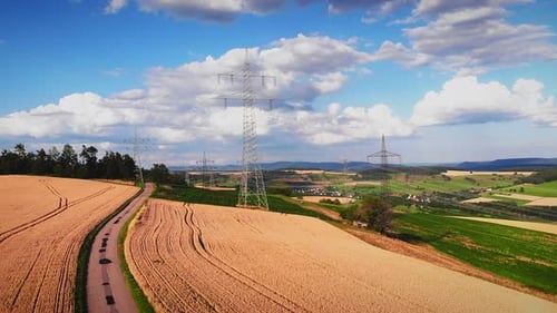 Aerial View of Golden Wheat Fields and Powerlines
