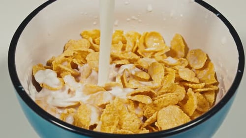 Milk Pouring Over Cereal for Nutritious Breakfast