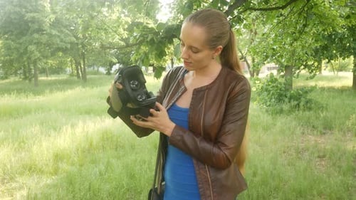 Woman Is Looking At A Virtual Reality Helmet In The Park