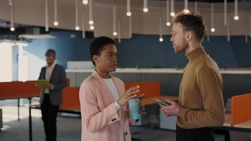 Brunette Haired Man and Woman in Casual Wear Standing Together at Office Center with Modern Gadgets