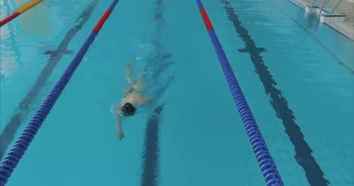 Woman Swimmer Swims Crawl in the Pool Blue Water