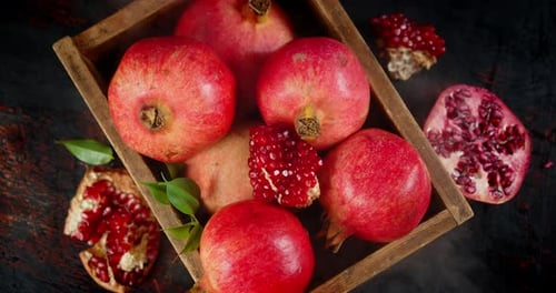 Pomegranates on Wooden Tray with Cool Steam.